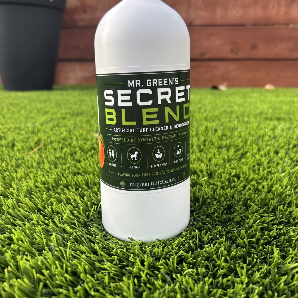 A 32 oz bottle of Mr. Green's Secret Blend standing on artificial turf