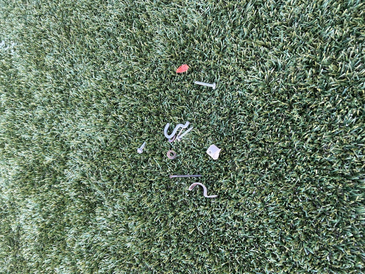 Mr Green Turf Clean crew agitating coastal turf infill before enzyme rinse